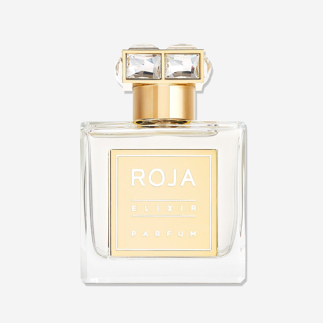 A clear glass bottle of Roja Parfums Elixir Pour Femme with a gold label and cap, topped with two square-cut gemstones, set against a white backgroundâ€”an ethereal fragrance blending vanilla amber musk notes.