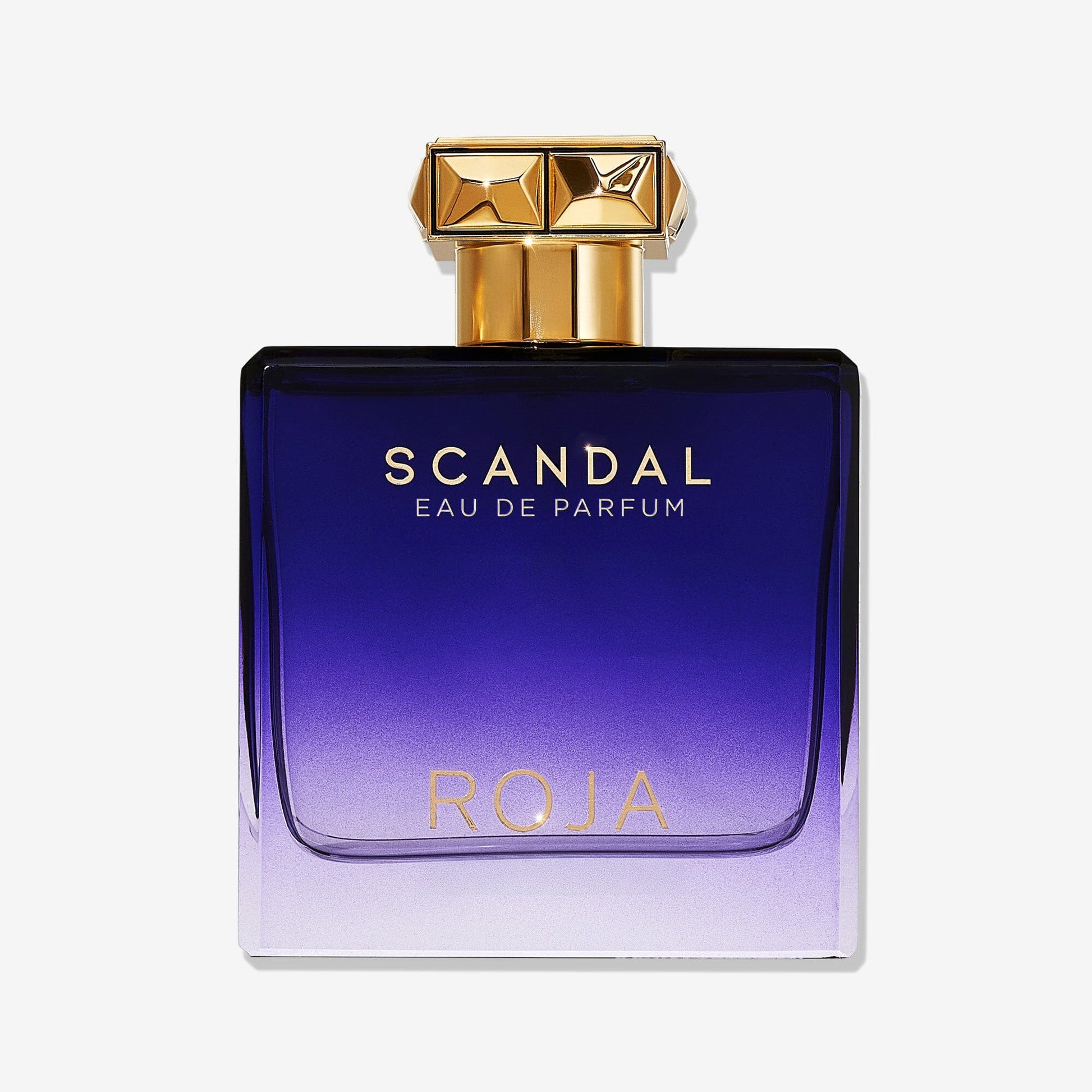 A rectangular perfume bottle with a gold cap features a gradient from deep purple to light lavender, gold Scandal Pour Homme lettering, and holds ROJA Parfums modern FougÃ¨re cologne for men.