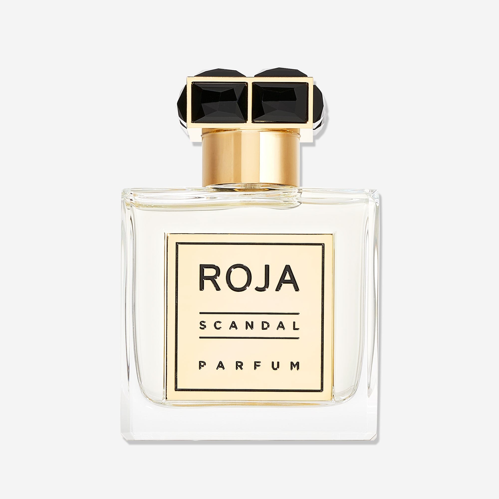 A clear glass bottle of Scandal Pour Homme by Roja Parfums, featuring a gold and black rectangular cap and a gold front labelâ€”an elegant choice for the modern gentleman who appreciates a refined FougÃ¨re fragrance.